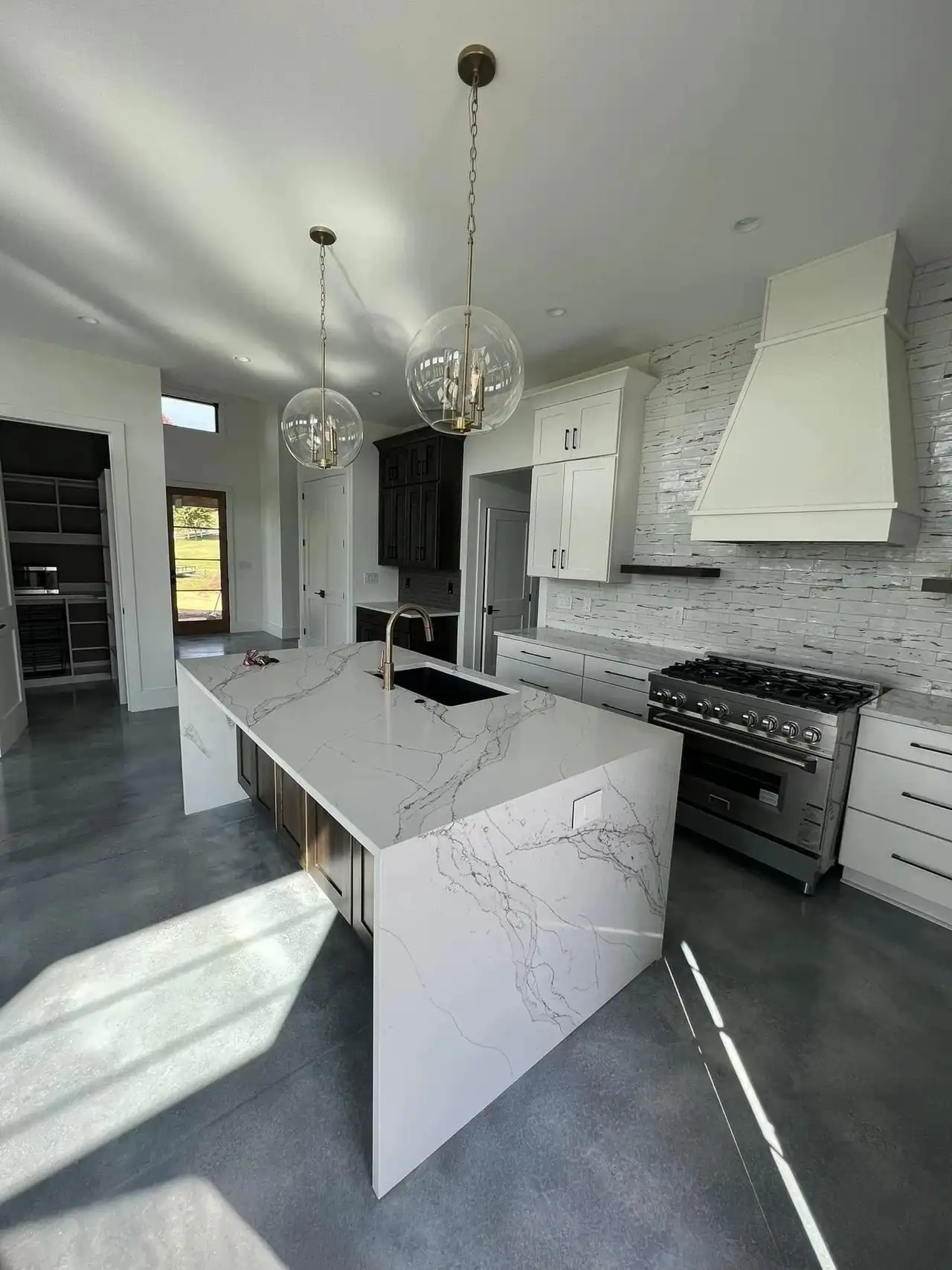 A finished kitchen remodel with a quartz waterfall island, Asheville NC